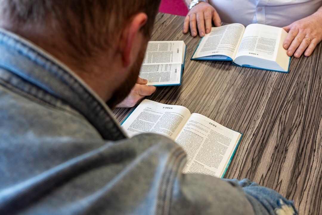Small group of people discussing around a table with notebooks